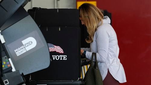 FILE - Voter Maria Mendoza completes her ballot for Florida's primary election behind a privacy screen, Tuesday, Aug. 20, 2024, at a polling place inside a fire station in Coral Gables, Fla. (AP Photo/Rebecca Blackwell, File)