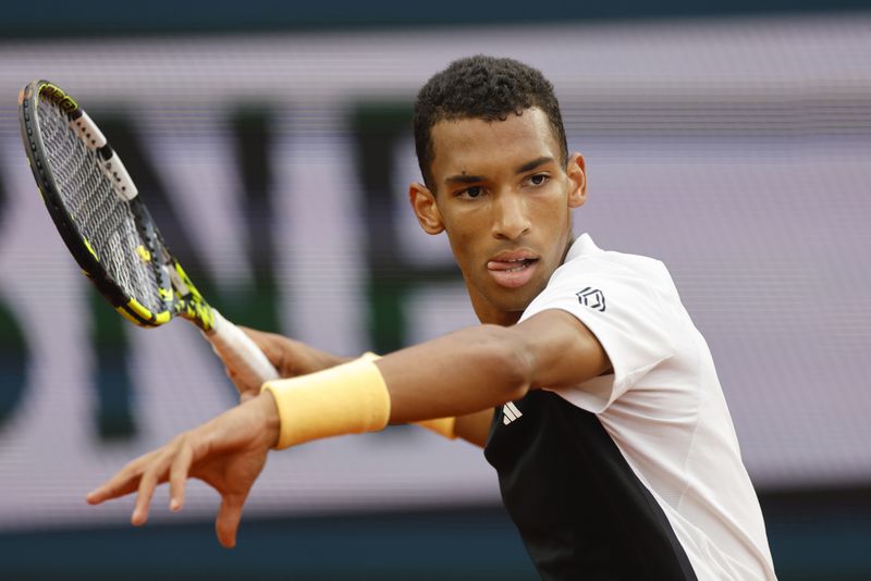 Canada's Felix Auger-Aliassime plays a shot against Ben Shelton of the U.S. during their third round match of the French Open tennis tournament at the Roland Garros stadium in Paris, Saturday, June 1, 2024. (AP Photo/Jean-Francois Badias)