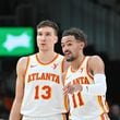 Atlanta Hawks guard Trae Young (11) confers with Atlanta Hawks guard Bogdan Bogdanovic (13) during the fourth quarter in an NBA basketball game at State Farm Arena, Saturday, February 3, 2024, in Atlanta. Atlanta Hawks won 141-134 in overtime. (Hyosub Shin / Hyosub.Shin@ajc.com)