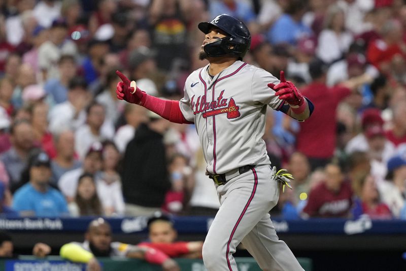 Atlanta Braves' Orlando Arcia reacts after hitting a home run against Philadelphia Phillies pitcher Ranger Suárez during the third inning of a baseball game, Friday, Aug. 30, 2024, in Philadelphia. (AP Photo/Matt Slocum)