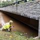 A GDOT bridge inspector checks for damage where Northside Drive NW crosses Peachtree Creek in Atlanta on Friday, Sept. 27, 2024 following a night of heavy rain from Hurricane Helene.   Ben Gray for the Atlanta Journal-Constitution