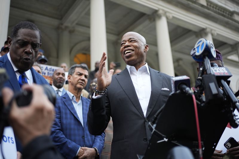 New York City Mayor Eric Adams speaks while surrounded by faith leaders and other supporters during a rally and prayer vigil on the steps of City Hall in New York, Tuesday, Oct. 1, 2024. (AP Photo/Seth Wenig)