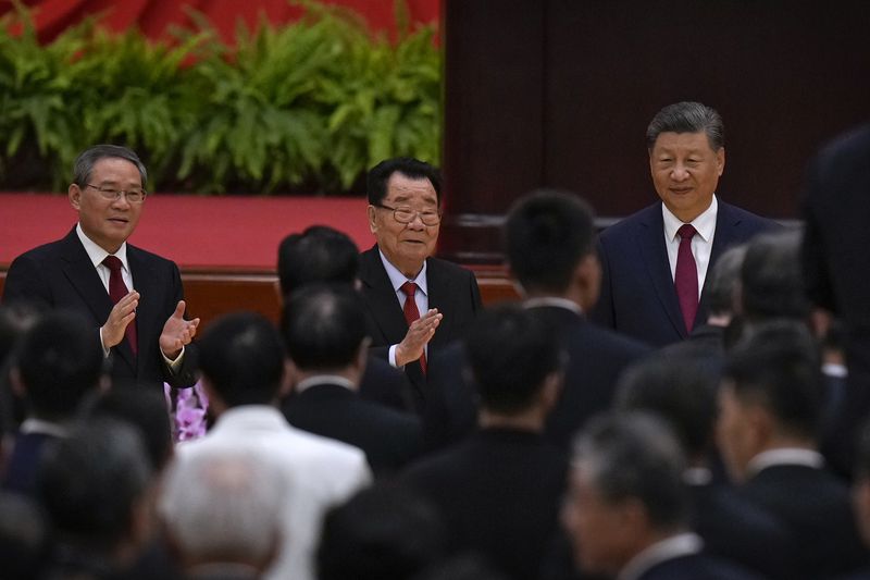 Leaders from right, Chinese President Xi Jinping, retired leader Li Ruihuan and Premier Li Qiang arrive for a dinner marking the 75th anniversary of the founding of the People's Republic of China, at the Great Hall of the People in Beijing, Monday, Sept. 30, 2024. (AP Photo/Andy Wong)