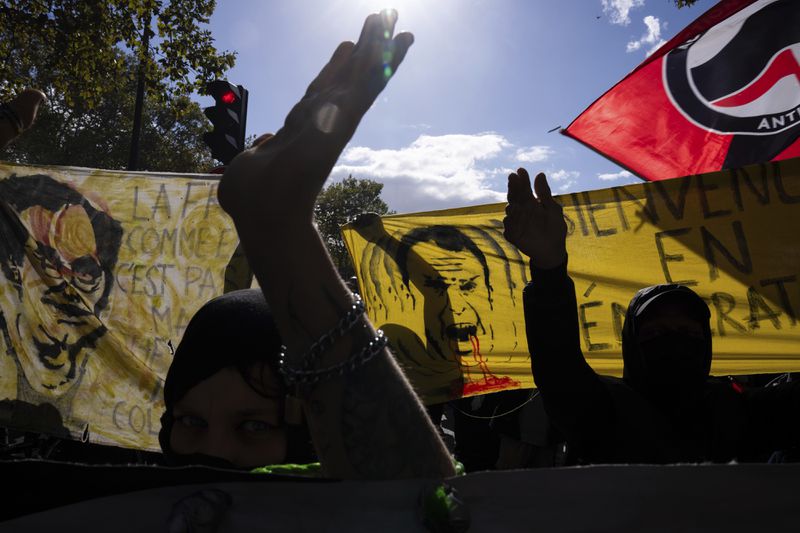 Protesters march during a rally against the new government of French Prime Minister Michel Barnier, in Paris, Tuesday, Oct. 1, 2024. (AP Photo/Louise Delmotte)