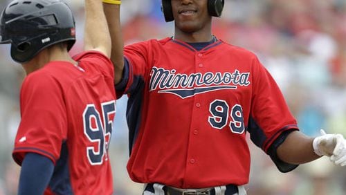 Adam Walker is greeted after a two-run homer in a 2014 spring training game against the Red Sox. The Braves claimed the power-hitting minor league minor league outfielder off waivers last week and outrighted him to the minors on Tuesday after he cleared waivers. (AP file photo)