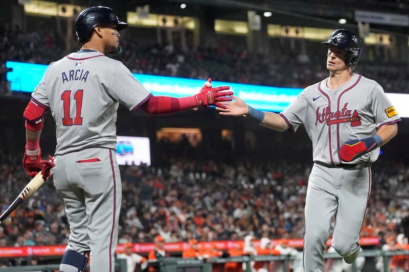 Atlanta Braves' Luke Williams, right, is congratulated by Orlando Arcia after scoring against the San Francisco Giants during the 10th inning of a baseball game in San Francisco, Tuesday, Aug. 13, 2024. (AP Photo/Jeff Chiu)