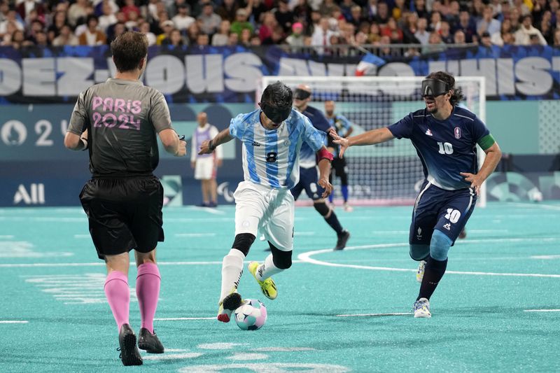 Argentina's Osvaldo Fernandez and France's Frederic Villeroux, right, fight for the ball during the blind football gold medal match at the 2024 Paralympics, Saturday, Sept. 7, 2024, in Paris, France. (AP Photo/Christophe Ena)