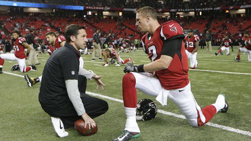 Atlanta Falcons quarterback Matt Ryan (2) speaks with Offensive Coordinator Kyle Shanahan before the first half of an NFL football game between the Atlanta Falcons and the Kansas City Chiefs, Sunday, Dec. 4, 2016, in Atlanta. (AP Photo/John Bazemore)