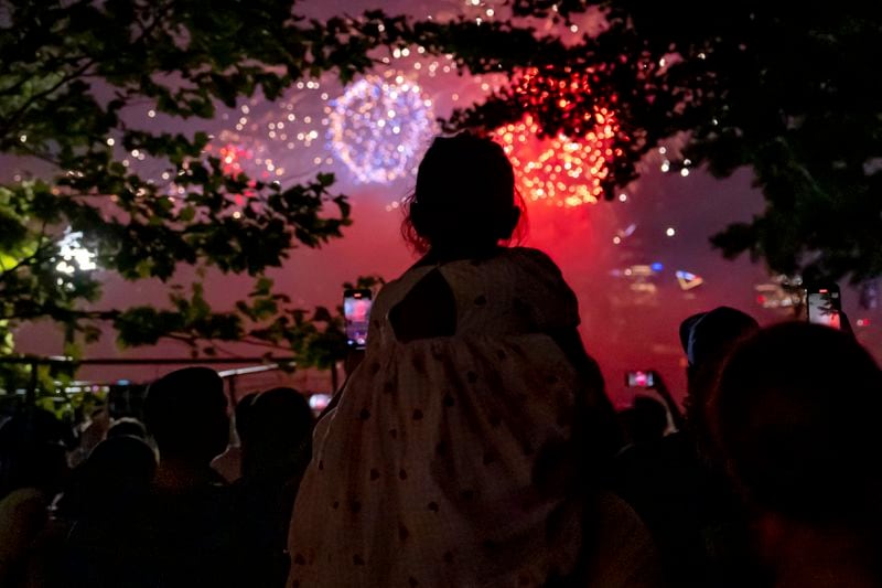 A girl watches Macy's Fourth of July fireworks over New York, Thursday, July 4, 2024, in Hoboken, N.J. (AP Photo/Julia Nikhinson)