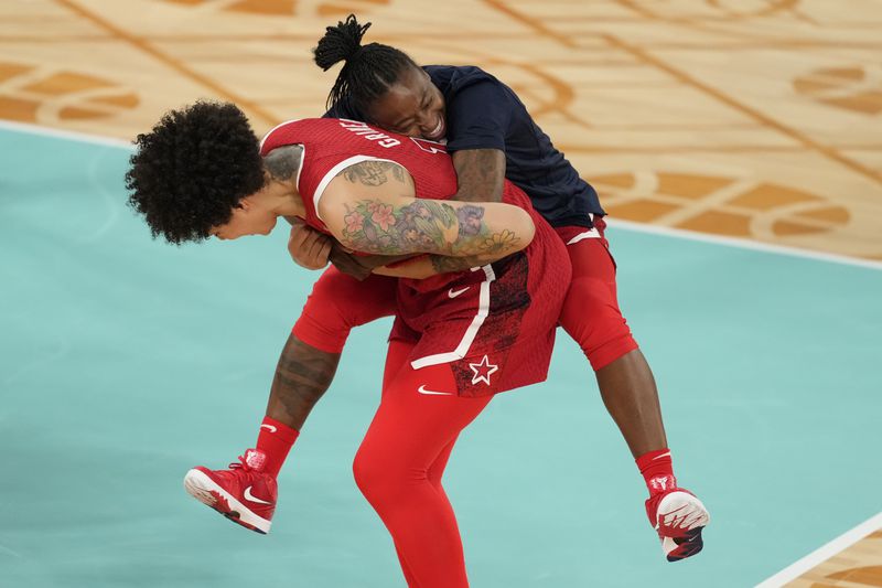 United States' Brittney Griner (15) and United States' Chelsea Gray (8) celebrate after a women's gold medal basketball game at Bercy Arena at the 2024 Summer Olympics, Sunday, Aug. 11, 2024, in Paris, France. (AP Photo/Michael Conroy)