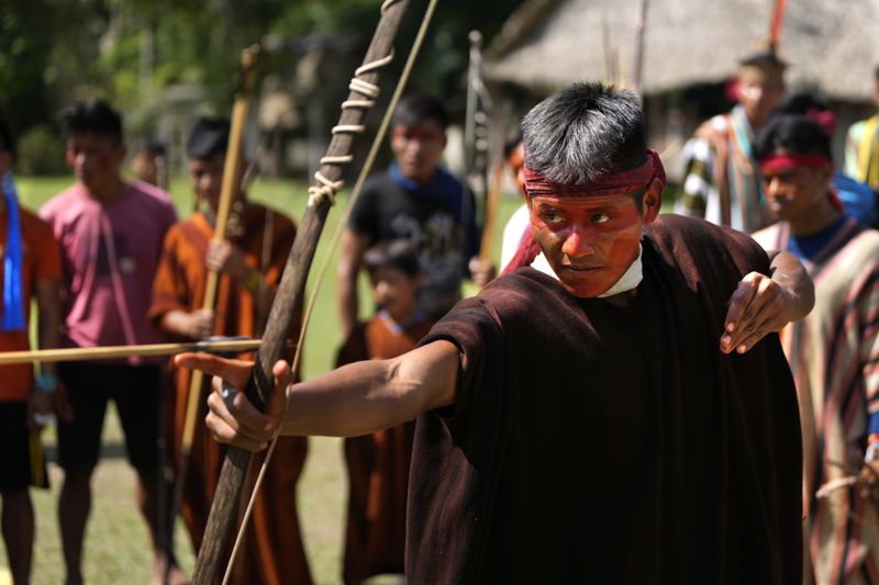 An Ashaninka Indigenous youth participates in a bow and arrow competition during the annual celebration recognizing the Ashaninka territory in the Apiwtxa village, Acre state, Brazil, Sunday, June 23, 2024. (AP Photo/Jorge Saenz)