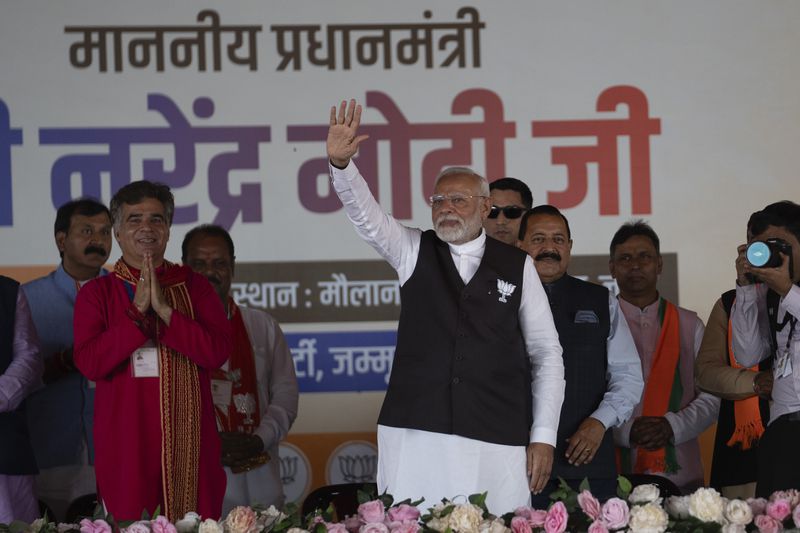 FILE- Indian Prime Minister Narendra Modi, center, waves to supporters during a campaign rally of Jammu and Kashmir Assembly elections in Jammu, India, Sept. 28, 2024. (AP Photo/Channi Anand, File)