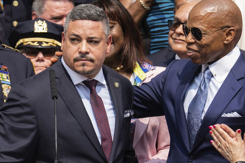 FILE - Edward A. Caban, left, speaks after being sworn in as NYPD police commissioner outside New York City Police Department 40th Precinct, July 17, 2023, in New York. Mayor Eric Adams on the right. (AP Photo/Jeenah Moon, File)