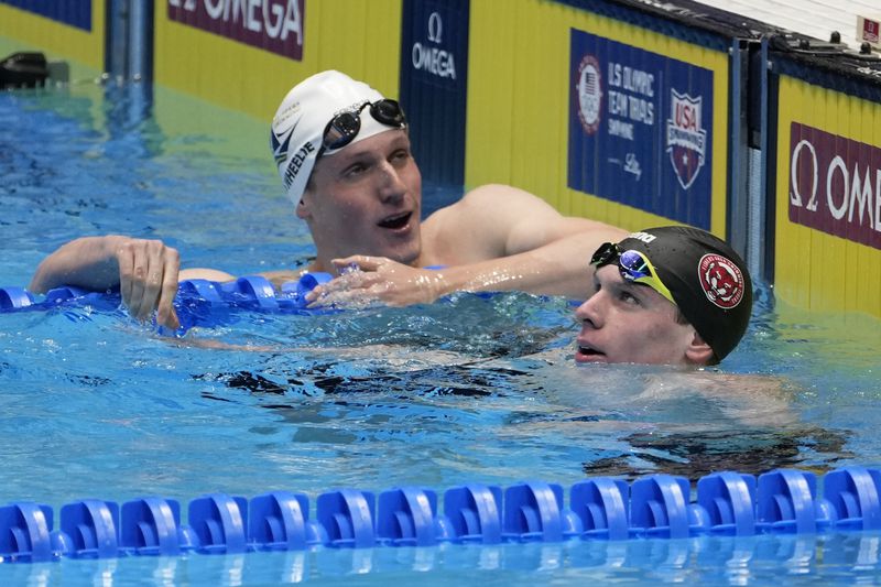Luke Whitlock and Carson Walker wait for times during the Men's 400 freestyle preliminaries Saturday, June 15, 2024, at the US Swimming Olympic Trials in Indianapoils. (AP Photo/Darron Cummings)