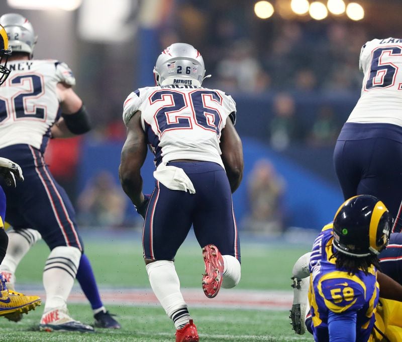 New England Patriots running back Sony Michel (26) finds a hole in the fourth quarter against the Los Angeles Rams during Super Bowl LIII on Sunday, Feb. 3, 2019 at Mercedes-Benz Stadium in Atlanta. (Curtis Compton / curtis.compton@ajc.com)