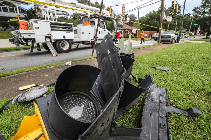 City of East Point utility workers were busy Tuesday replacing poles, downed wires and signal lights at the intersection of Church Street and Linwood Avenue where Morehouse College students Hugh Douglas and Christion Files Jr. died in a car crash Monday. (John Spink / John.Spink@ajc.com)

