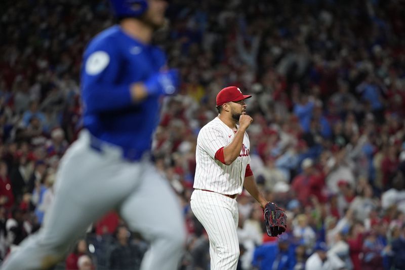 Philadelphia Phillies' Carlos Estévez, right, celebrates after the Phillies won a baseball game against the Chicago Cubs to clinch the NL East title, Monday, Sept. 23, 2024, in Philadelphia. (AP Photo/Matt Slocum)