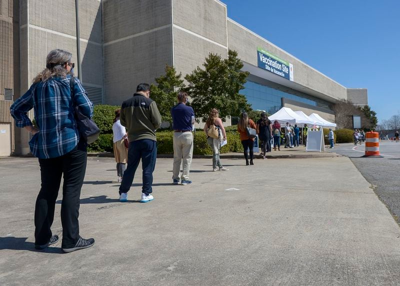 Lines form outside a Gwinnett County vaccination site  Gwinnett Place Mall in Duluth on March 8, 2021. (Daniel Varnado for The AJC)