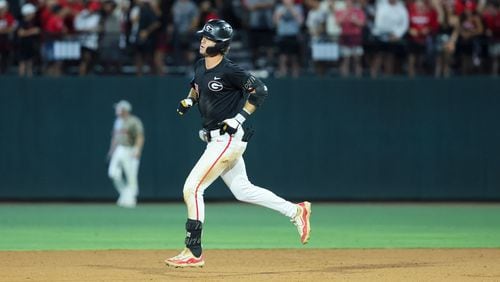 Georgia third baseman Charlie Condon jogs around the bases after hitting a solo home run during the ninth inning against N.C. State in Game 3 of the NCAA Super Regional at Foley Field, Monday, June 10, 2024, in Athens, Ga. Georgia lost 8-5. (Jason Getz / AJC)
