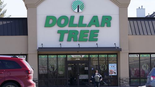 FILE - A woman leaves a Dollar Tree store in Urbandale, Iowa, on Feb. 25, 2021. Dollar Tree is slashing its full-year adjusted earnings and sales forecasts as its customers are taking an even more cautious approach to their spending and buying less. (AP Photo/Charlie Neibergall)