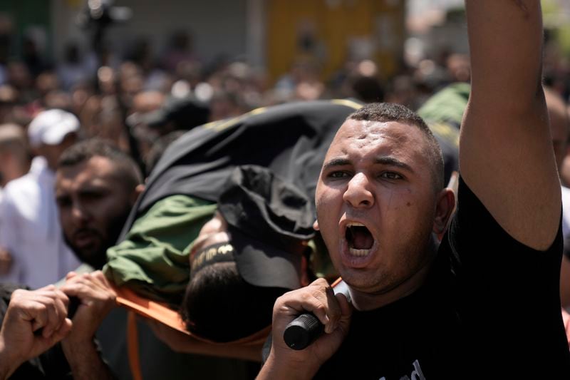 Mourners carry the body of Mustafa Marhi, an Islamic Jihad militant killed in a raid by Israeli forces in the village of Kafr Dan, near the West Bank city of Jenin, Wednesday, June 12, 2024. Hundreds of mourners gathered for the funeral of Palestinian men killed by Israeli fire during a raid in the northern West Bank village. A total of six men were killed by Israeli forces during Tuesday's raid on the village according to the Palestinian Health Ministry. (AP Photo/Majdi Mohammed)