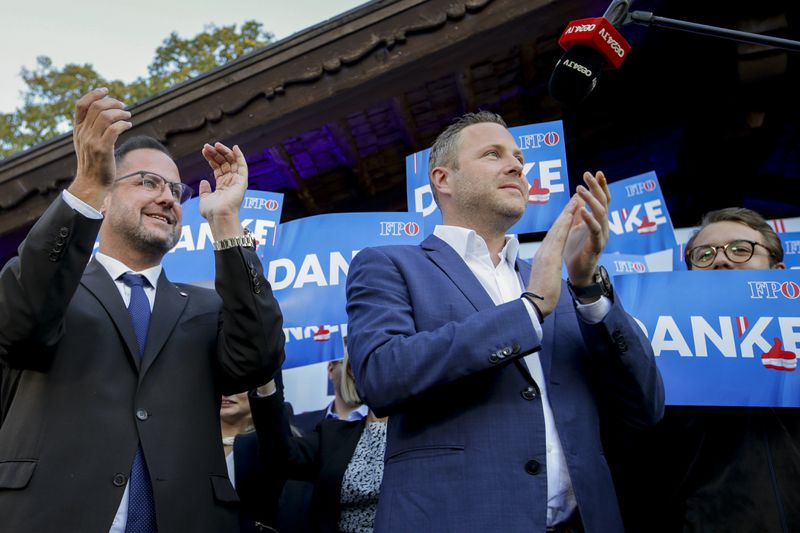 Michael Schnedlitz, right, and Christian Hafenecker of the Freedom Party of Austria cheer at the party headquarters in Vienna, Austria, Sunday, Sept. 29, 2024 upon seeing initial electoral projections. (AP Photo/Heinz-Peter Bader)