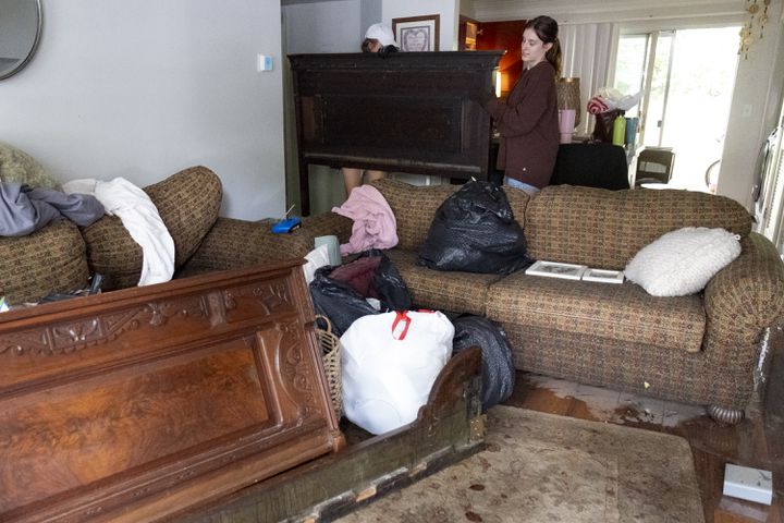 Lauren Bryant, right, helps her friend Hope Ferguson remove her bed while cleaning up Ferguson’s flooded apartment at the Peachtree Park Apartments in Atlanta on Saturday, Sept. 28, 2024.   Ben Gray for the Atlanta Journal-Constitution