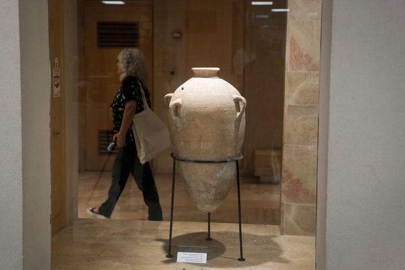 A rare bronze-era jar, newly reassembled, returned to public exhibition after a four-year-old accidentally broke the jar in August during a visit in Hecht Museum of the University of Haifa, Israel, on Wednesday, Sept. 11, 2024. (AP Photo/Mahmoud Illean)