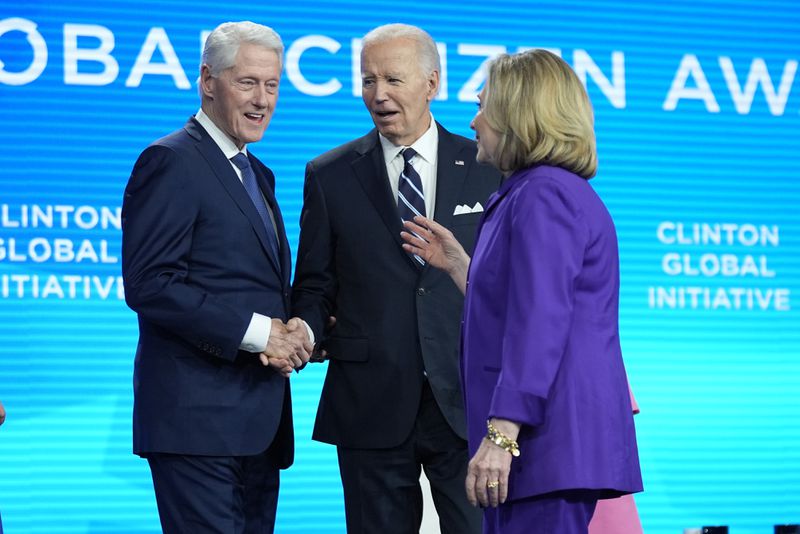 President Joe Biden talks with former Secretary of State Hillary Clinton and former President Bill Clinton as he is presented with the Global Citizen Award at the Clinton Global Initiative Monday, Sept. 23, 2024, in New York. (AP Photo/Manuel Balce Ceneta)