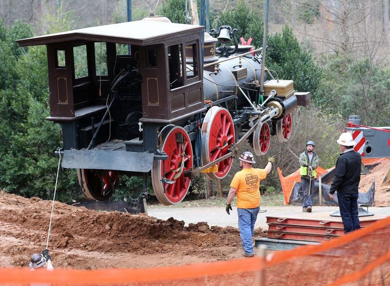 Workers haul the 53,000 pound Texas out of its home at the Cyclorama in Grant Park on Dec. 21, 2015. The locomotive began a trip that day that eventually brought it to the Atlanta History Center. Ben Gray / bgray@ajc.com