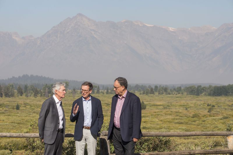 Federal Reserve Chairman Jerome Powell, left, Governor of the Bank of Canada Tiff Macklem, center, and Governor of the Bank of England Andrew Bailey chat outside the Jackson Hole Economic Symposium at Jackson Lake Lodge in Grand Teton National Park near Moran, Wyo., on Friday, Aug. 23, 2024. (AP Photo Amber Baesler)