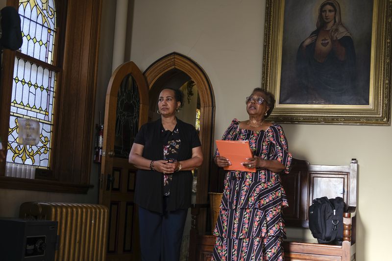 Parishioners wait for Mass at St. Peter the Apostle Catholic Church in Reading, Pa., on Sunday, June 16, 2024. (AP Photo/Luis Andres Henao)