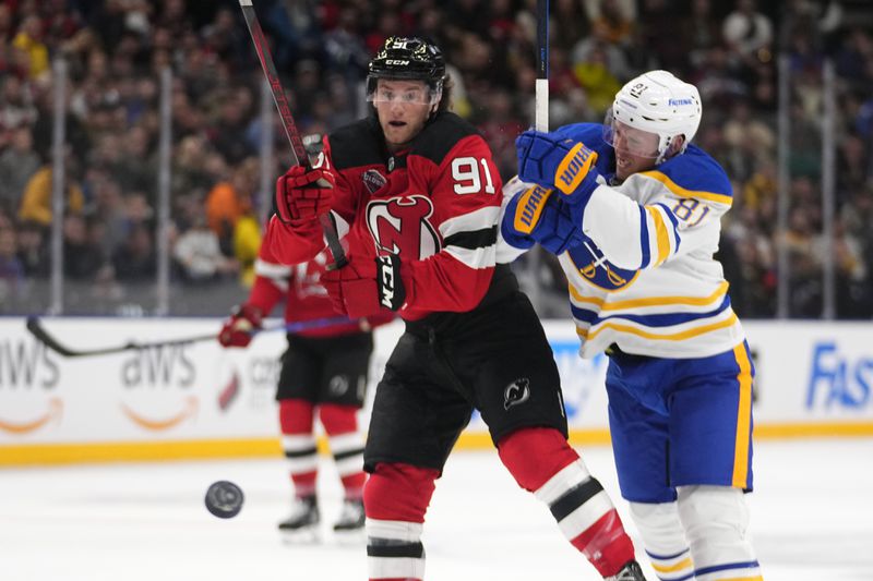 Buffalo Sabres' Ukko-Pekka Luukkonen challenges New Jersey Devils' Dawson Mercer during the NHL hockey game between Buffalo Sabres and New Jersey Devils, in Prague, Czech Republic, Saturday, Oct. 5, 2024. (AP Photo/Petr David Josek)