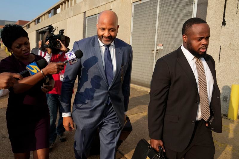 Attorney John Keith Perry, center, leaves the federal courthouse with his client former Memphis police officer Tadarrius Bean after the first day of jury selection of the trial in the Tyre Nichols case Monday, Sept. 9, 2024, in Memphis, Tenn. (AP Photo/George Walker IV)