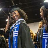 Lexington Jackson make her way to her seat during Spelman College’s 137th commencement at the Georgia International Convention Center on Sunday, May 19, 2024. Angela Bassett, the keynote speaker, and Supreme Court Justice Ketanji Brown Jackson were both awarded honorary degrees.  (Jenni Girtman for The Atlanta Journal-Constitution)