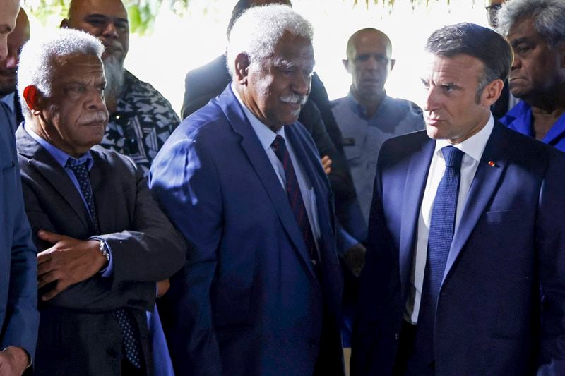 French President Emmanuel Macron, right, walks past New Caledonia's President Louis Mapou, left, and New Caledonia's Congress President Roch Wamytan following a meeting with New Caledonia's elected officials and local representatives at the French High Commissioner Louis Le Franc's residence in Noumea, New Caledonia, Thursday, May 23, 2024. Macron has landed in riot-hit New Caledonia, having crossed the globe by plane from Paris in a high-profile show of support for the French Pacific archipelago wracked by deadly unrest and where indigenous people have long sought independence from France. (Ludovic Marin/Pool Photo via AP)