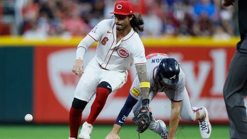 Cincinnati Reds second baseman Jonathan India, left, tries to control the ball as Atlanta Braves' Matt Olson slides safely into second base on a ball hit by Atlanta Braves' Ramon Laureano during the second inning of a baseball game Tuesday, Sept. 17, 2024, in Cincinnati. (AP Photo/Jay LaPrete)