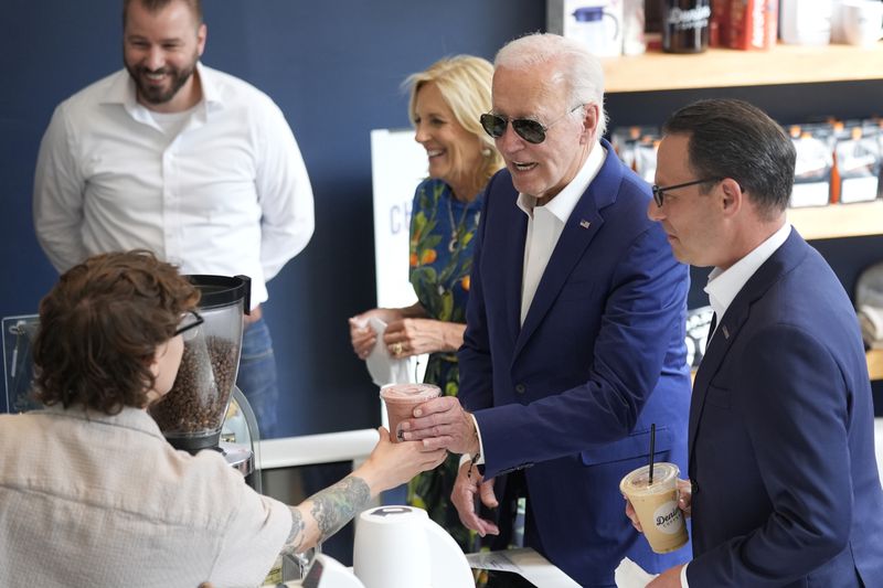 President Joe Biden, from second right, and first lady Jill Biden visit Denim Coffee after a campaign event in Harrisburg, Pa., on Sunday, July 7, 2024. (AP Photo/Manuel Balce Ceneta)