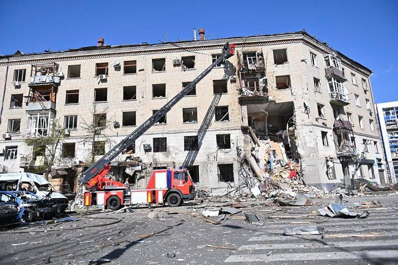 In this photo provided by the Ukrainian Emergency Service, rescuers work in a damaged apartment house after it was hit by Russian air bomb killing at least three and injuring 23, in Kharkiv, Ukraine, Saturday, June 22, 2024. (Ukrainian Emergency Service via AP)