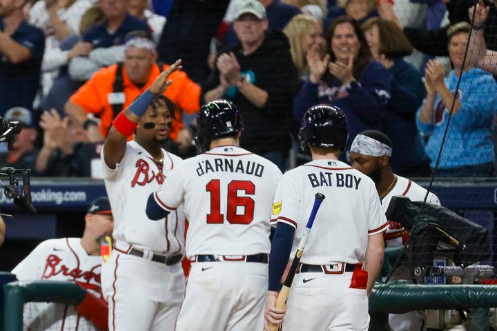 Atlanta Braves’ Travis d'Arnaud (16) celebrates after a two-run home run against the Philadelphia Phillies that scored Matt Olson during the seventh inning of NLDS Game 2 in Atlanta on Monday, Oct. 9, 2023.   (Miguel Martinez / Miguel.Martinezjimenez@ajc.com)