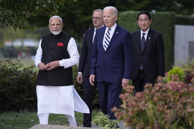 President Joe Biden, joined by Australia's Prime Minister Anthony Albanese, Japan's Prime Minister Fumio Kishida, and India's Prime Minister Narendra Modi, walk out to speak about a Quadrilateral Cancer Moonshot initiative on the sidelines of the Quad leaders summit at Archmere Academy in Claymont, Del., Saturday, Sept. 21, 2024. (AP Photo/Mark Schiefelbein)