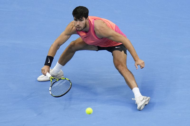 Carlos Alcaraz of Spain returns a shot from Jannik Sinner of Italy during their men's singles finals match of the China Open tennis tournament, at the National Tennis Center in Beijing, Wednesday, Oct. 2, 2024. (AP Photo/Andy Wong)