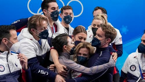 FILE - Madison Chock and Evan Bates, of the United States, reacts after the team ice dance program during the figure skating competition at the 2022 Winter Olympics, Monday, Feb. 7, 2022, in Beijing.The United States figure skating team was formally confirmed as the 2022 Beijing Olympics champion by a sports court ruling. It opens the way to the skaters getting their medals at a presentation ceremony at the Paris Summer Games. (AP Photo/Natacha Pisarenko, File)