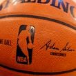 FILE - An NBA logo is seen on an official game ball before a basketball game, Feb. 1, 2014, in New York. The NBA said Wednesday, July 24, 2024, that it is not accepting Warner Bros. Discovery's $1.8 billion per year offer to continue its longtime relationship with the league and therefore has entered into a deal with Amazon Prime Video, a move that would mean this coming season would end a nearly four-decade run of games being on TNT. (AP Photo/Jason DeCrow, file)