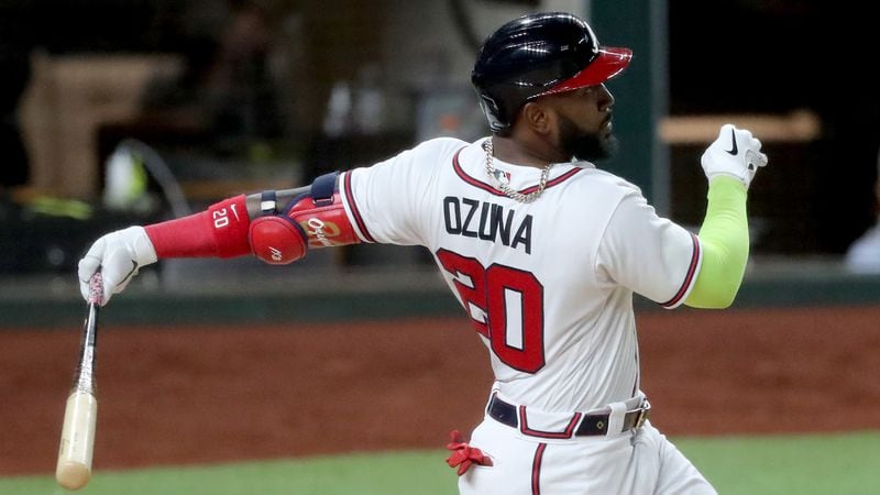 Braves designated hitter Marcell Ozuna hits a solo home run against the Los Angeles Dodgers during the fourth inning in Game 4 of the National League Championship Series Thursday, Oct. 15, 2020, at Globe Life Field in Arlington, Texas. (Curtis Compton/Curtis.Compton@ajc.com)