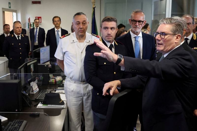 British Prime Minister Keir Starmer, right, visits the National Coordination Center, on the occasion of his visit to Rome, Monday, Sept. 16, 2024. (Phil Noble/Pool Photo via AP)