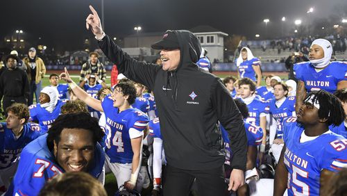 Walton Raider head coach Daniel Brunner is seen with his players after beating Camden County 41-25 in a GHSA semifinal game Friday, December 1, 2023. (Daniel Varnado/For the AJC)