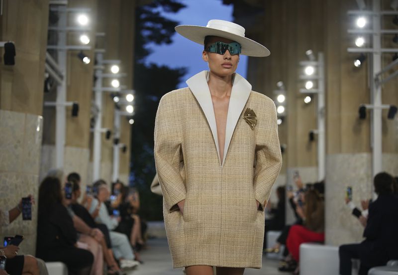A model wears a creation by Louis Vuitton during a fashion show for the Cruise 2025 collection in the Park Guell in Barcelona, Spain, Thursday, May 23, 2024. (AP Photo/Joan Mateu)