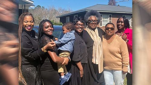 After the funeral of 64-year-old Andrew J. Mitchell on Feb. 29, his relatives attended a repast, then gathered again at one of his sisters homes. Dozens of family members later fell ill. Pictured outside the sisters home on that day are, left to right, Abrigail Johnson, Margaret Mansfield, Brenden Mansfield (baby), Jacqueline Mansfield, Dorothy Johnson, Tonya Thomas and Nakimbra Savage. Thomas is now in critical condition at Piedmont Fayette Hospital. SPECIAL