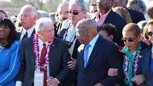 U.S. Sen. Jeff Sessions (R-Alabama) clasps the hand of U.S. Rep. John Lewis (D-Georgia) during a commemoration of the “Bloody Sunday” march for voting rights on the Edmund Pettus Bridge in Selma. (Facebook photo.)